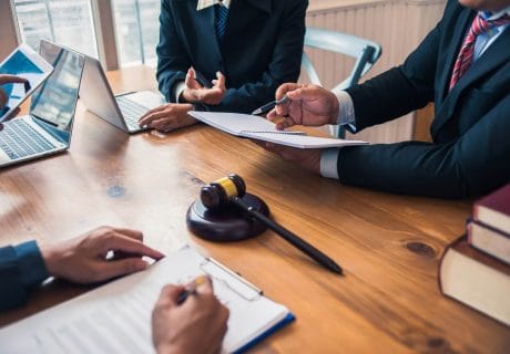 66cbc84cccc953215a154d82_Lawyers-sitting-at-a-table-dicussing-a-case